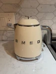 *used* With Broken Lid -smeg Retro Electric Mini Kettle Model KLF05CRUS Creme. Price: $65.99.