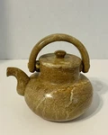 Carved Brown Stone Tea Pot With Swivel Handle Used. Price: $24.00.