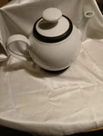 Vintage White Ceramic Tea Kettle With Rubber Go Around The Bottom Used. Price: $39.99.